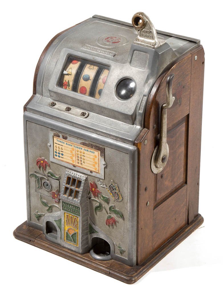 PACE MANUFACTURING COMPANY (CHICAGO, IL) FIVE-CENT: PACE MANUFACTURING COMPANY (CHICAGO, IL) FIVE-CENT "JAK-POT" SLOT MACHINE, with original polychrome-painted decoration and decals to each side of oak case. Circa 1925-1935. 24 1/2" HOA, 15" WOA, 14" D