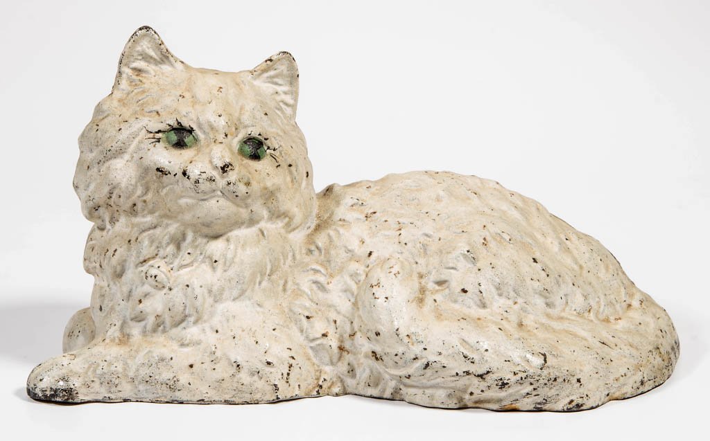 RECLINING PERSIAN CAT CAST-IRON DOORSTOP: RECLINING PERSIAN CAT CAST-IRON DOORSTOP, full, hollow figure, interior stamped "HUBLEY", numbered "335", original paint. Hubley Manufacturing Co. Second quarter 20th century. 5 1/2" H, 10 1/2" L. Pro