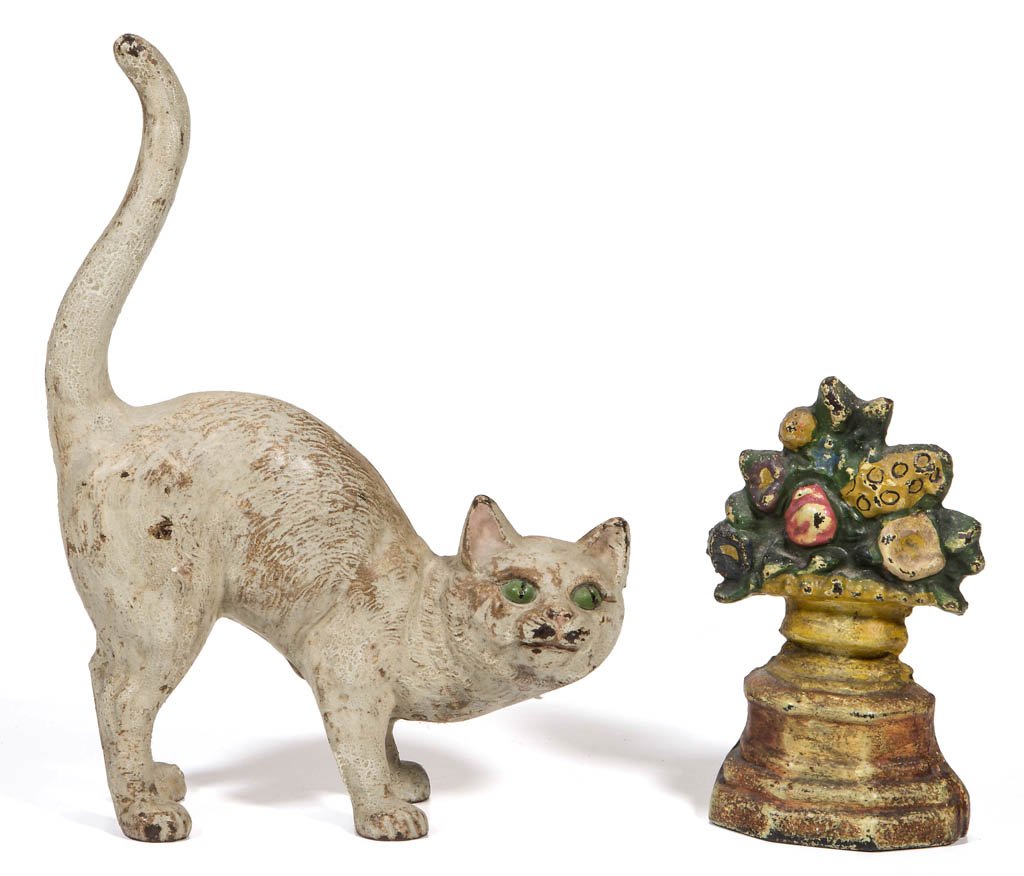 ASSORTED FIGURAL CAST-IRON DOORSTOPS, LOT OF TWO: ASSORTED FIGURAL CAST-IRON DOORSTOPS, LOT OF TWO, comprising a Hubley Tabby Cat and a small Urn of Flowers, original paint. First half 20th century. 11" and 6 1/2" H. Provenance: Property of a Winches