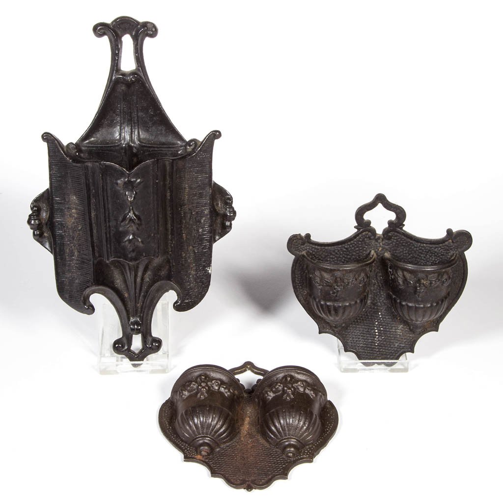 ASSORTED BRADLEY & HUBBARD CAST IRON MATCH HOLDERS /: ASSORTED BRADLEY & HUBBARD CAST IRON MATCH HOLDERS / SAFES, LOT OF THREE, wall mounts, comprising two examples with double urns on a stylized heart-form plate; and a stylized panel and scroll example