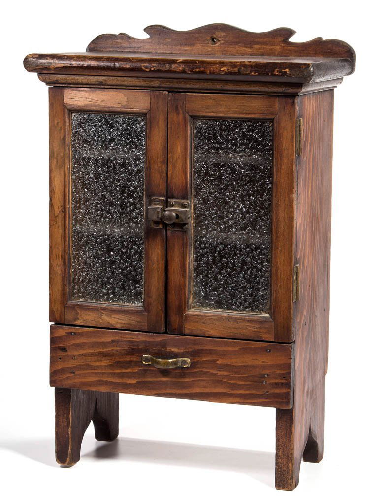 AMERICAN COUNTRY PINE CHILD'S / DOLL'S CUPBOARD: AMERICAN COUNTRY PINE CHILD'S / DOLL'S CUPBOARD, the shaped gallery back over a rectangular top with rounded edge above two hinged doors fitted with glass panes over a single drawer, raised on extende