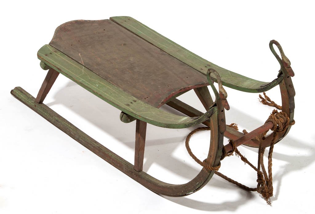 AMERICAN OAK AND POLAR PAINTED CHILD'S SLED: AMERICAN OAK AND POLAR PAINTED CHILD'S SLED, with iron runner blades and swan-form hand holds. Original dry green and red painted surface with pin striping. Fourth quarter 19th century. 14 1/2" HOA, 3