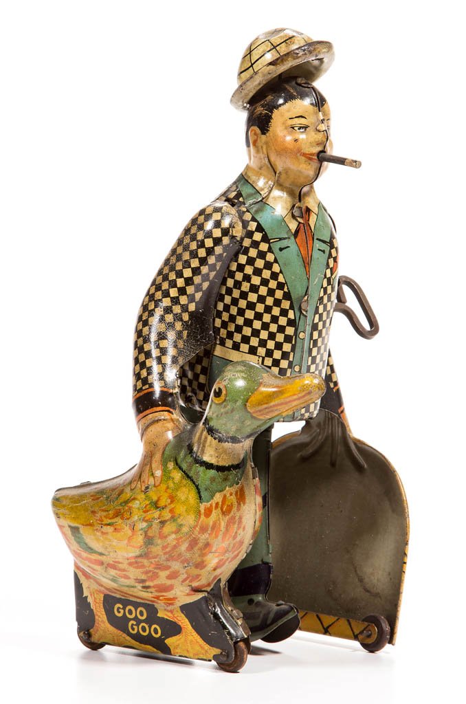 MARX JOE PENNER AND HIS DUCK GOO GOO WALKING WIND-UP: MARX JOE PENNER AND HIS DUCK GOO GOO WALKING WIND-UP TIN TOY, carrying a duck and a basket, original moving cigar and pop-up hat. Second quarter 20th century. 8" H. Provenance: From the Ed & Kay Winni