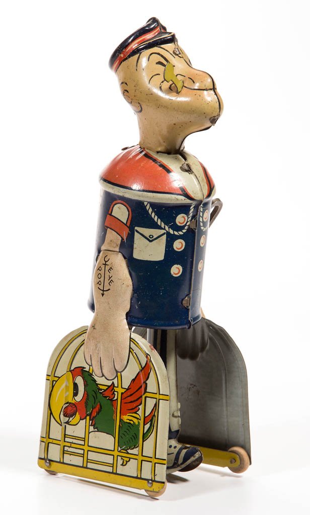 MARX / CHEIN WALKING POPEYE WIND-UP TIN TOY: MARX / CHEIN WALKING POPEYE WIND-UP TIN TOY, carrying two parrot cages, original pipe and wooden roller wheels, unmarked. Second quarter 20th century. 8" H. Provenance: Property of a Virginia private 