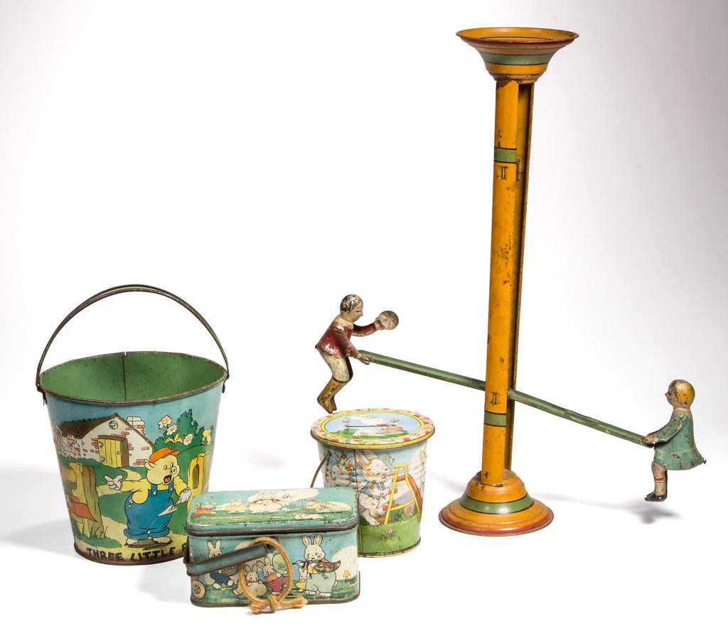 ASSORTED TIN TOYS, LOT OF FOUR: ASSORTED TIN TOYS, LOT OF FOUR, comprising a Gibbs see-saw / teeter-totter, a Three Little Pigs sand pail, a Peter Rabbit lunch box, and a later pail-form bank. 20th century. 14 1/2" HOA. Provenance: 