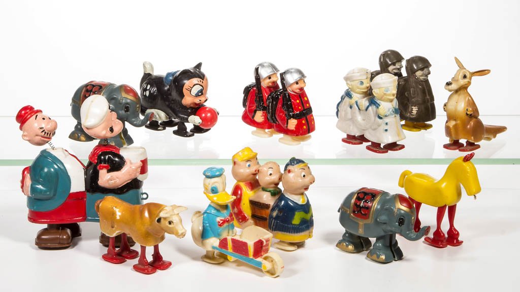 ASSORTED PLASTIC RAMP WALKER TOYS, LOT OF 12: ASSORTED PLASTIC RAMP WALKER TOYS, LOT OF 12, including Marx Popeye and Wimpy with nodder heads, Marx Three Little Pigs, soldiers, sailors, etc. 20th century. 2 1/4" to 5" HOA. Provenance: From the Do
