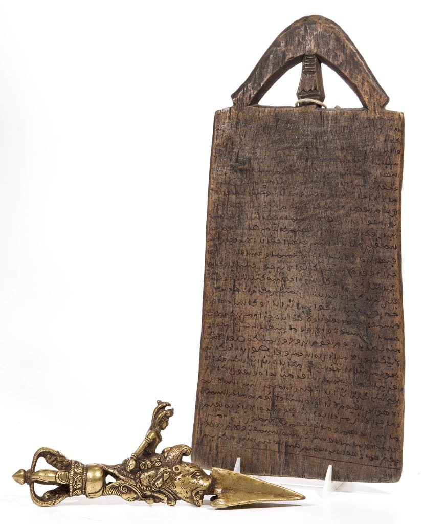 ETHNIC RELIGIOUS / CULTURAL ARTICLES, LOT OF TWO: ETHNIC RELIGIOUS / CULTURAL ARTICLES, LOT OF TWO, comprising a brass Tibetan Buddhist "Phurba" or "Kila" ceremonial "tent stake", often mistaken for a dagger, and a wooden Mali / Timbuktu writing boar
