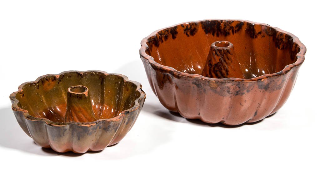 AMERICAN EARTHENWARE MOLDS, LOT OF TWO: AMERICAN EARTHENWARE MOLDS, LOT OF TWO, lead-glazed, comprising a large mold with impressed "10" on bottom and a small undecorated mold. Third quarter 19th century. 2" and 3" H. Provenance: From the c