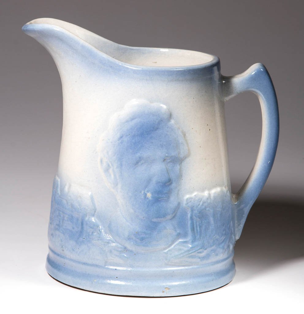 UHL POTTERY BLUE AND WHITE SALT-GLAZED CERAMIC PITCHER: UHL POTTERY BLUE AND WHITE SALT-GLAZED CERAMIC PITCHER, Lincoln Head pattern, with "UHL" mark to underside. Uhl Pottery Company, Huntington, IN. First quarter 20th century. 8 1/8" HOA. Provenance: Pro