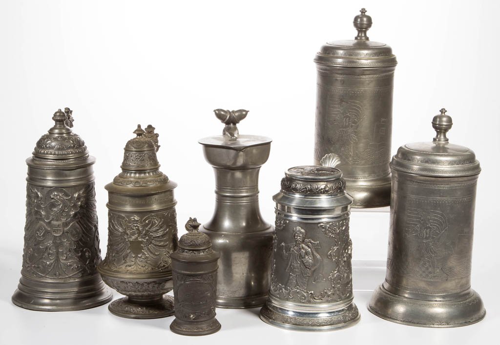 ASSORTED PEWTER STEINS, LOT OF SEVEN: ASSORTED PEWTER STEINS, LOT OF SEVEN, including a pair with engraved and punched decorations depicting a soldier holding a sword and a flag, and two featuring a Prussian eagle in relief and engraved w