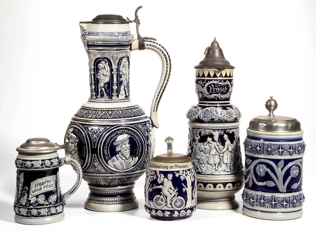 ASSORTED GERMAN STONEWARE STEINS, LOT OF FIVE: ASSORTED GERMAN STONEWARE STEINS, LOT OF FIVE, relief-molded decorations, markings include Wick-Werke, Eckhardt & Engler, Gertz (limited edition), and Albert Jacob Thewalt. 20th century. 6" to 17" HOA