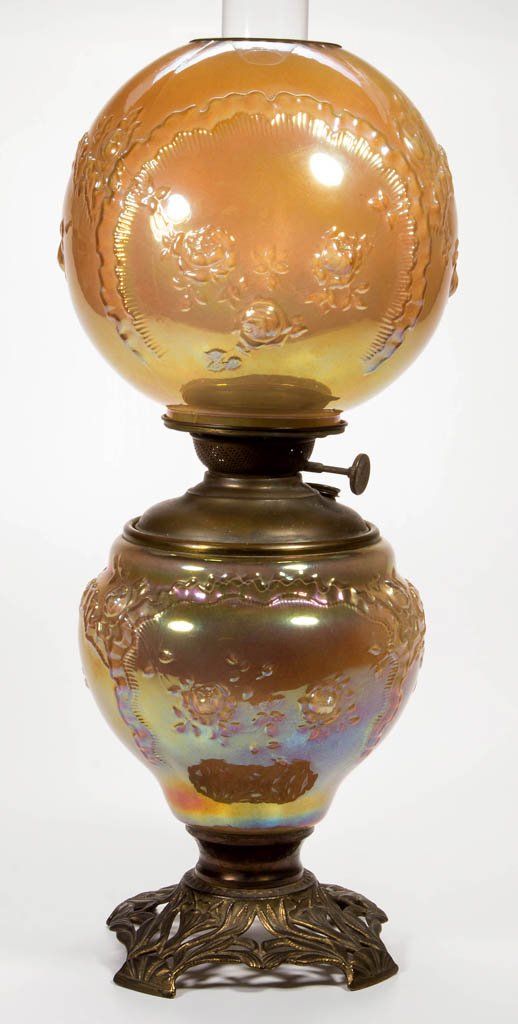 PITTSBURGH "ROSES AND RUFFLES / RIBBONS" CARNIVAL GLASS: PITTSBURGH "ROSES AND RUFFLES / RIBBONS" CARNIVAL GLASS PARLOR LAMP, marigold iridescent, matching patterned ball-form shade with brass trim ring, urn-form glass font holder with metal liner and brass