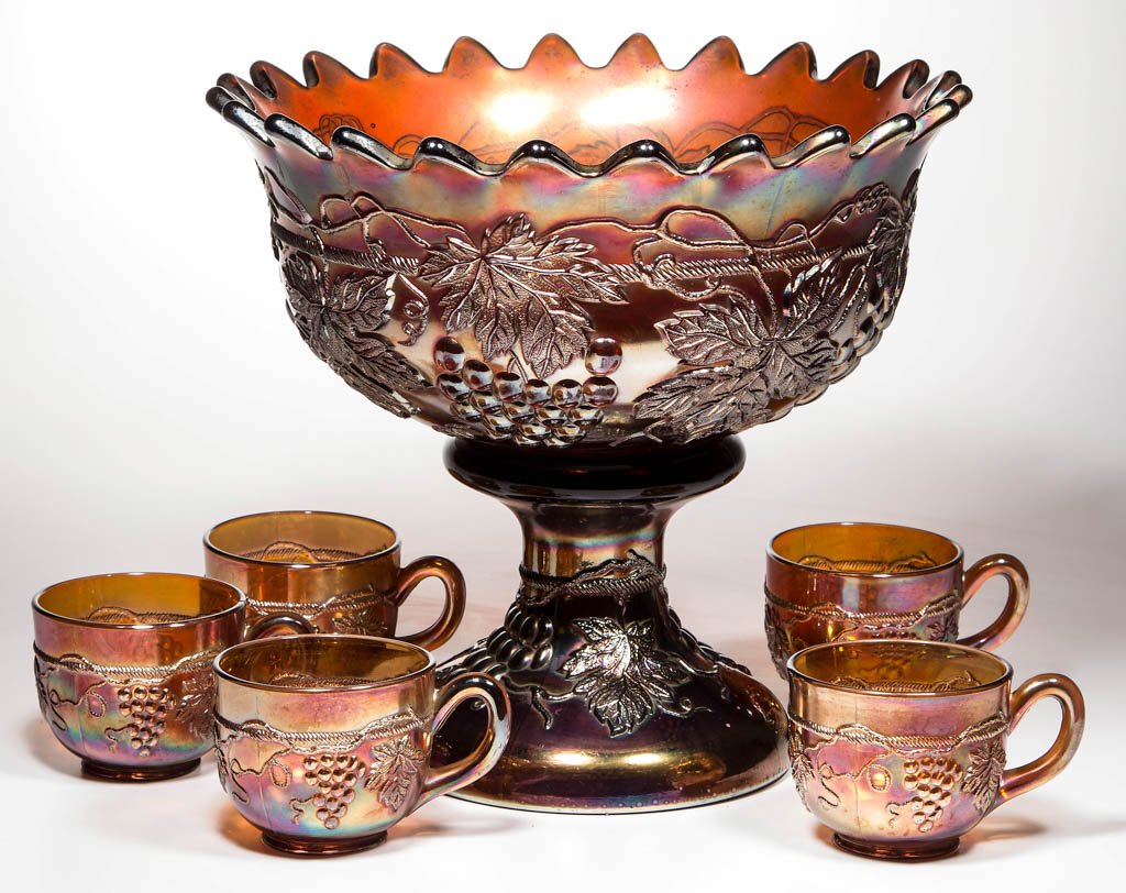 NORTHWOOD "GRAPE AND CABLE" CARNIVAL GLASS SEVEN-PIECE: NORTHWOOD "GRAPE AND CABLE" CARNIVAL GLASS SEVEN-PIECE PUNCH SET, light amethyst/purple iridescent, comprising scalloped-rim bowl, dark amethyst pedestal base with internal rib pattern, and five punch