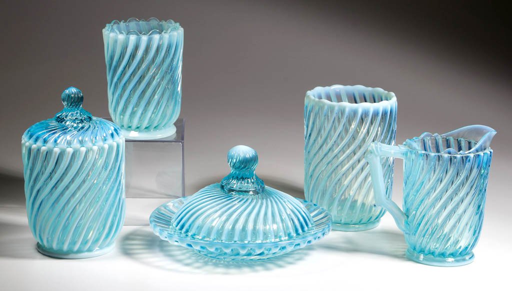 BEATTY SWIRL FIVE-PIECE TABLE SET: BEATTY SWIRL FIVE-PIECE TABLE SET, blue opalescent, comprising a butter dish, celery vase, covered sugar, creamer, and spooner. A. J. Beatty & Sons. Circa 1889. 4 1/4" to 6 5/8" HOA, butter 7 1/4" D.