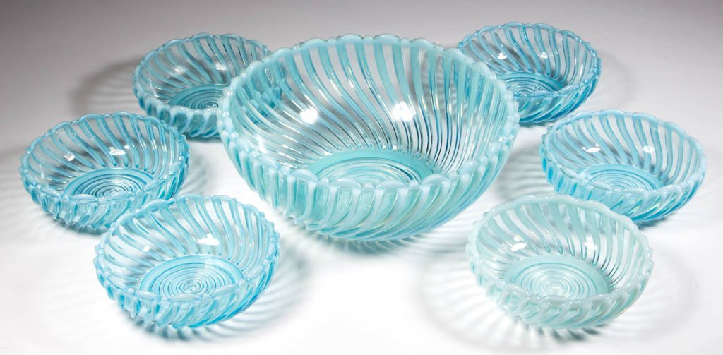 BEATTY SWIRL SEVEN-PIECE BERRY SET: BEATTY SWIRL SEVEN-PIECE BERRY SET, blue opalescent, comprising a master berry bowl and six berry dishes. A. J. Beatty & Sons. Circa 1889. 4 1/2" to 8 1/4" DOA. Literature: Parallels Heacock/Elmore - 