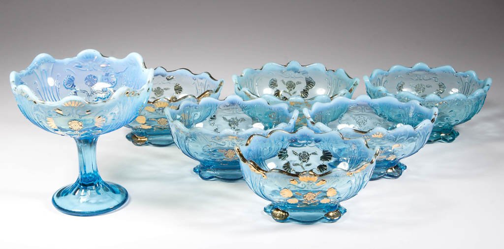 CARNELIAN (OMN) / EVERGLADES TABLE ARTICLES, LOT OF: CARNELIAN (OMN) / EVERGLADES TABLE ARTICLES, LOT OF SEVEN, blue opalescent with gilt decoration, comprising a jelly compote and six individual berry dishes. Northwood Glass Co. Circa 1903. 2 1/4" to 5