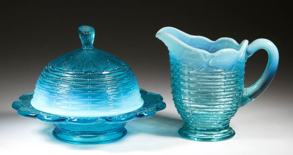 FROSTED LEAF AND BASKETWEAVE TABLE ARTICLES, LOT OF TWO: FROSTED LEAF AND BASKETWEAVE TABLE ARTICLES, LOT OF TWO, blue opalescent, comprising a butter dish and a creamer. H. Northwood Co. Circa 1905. Creamer 5 1/4" HOA, butter 7 1/2" DOA. Literature: Heacoc