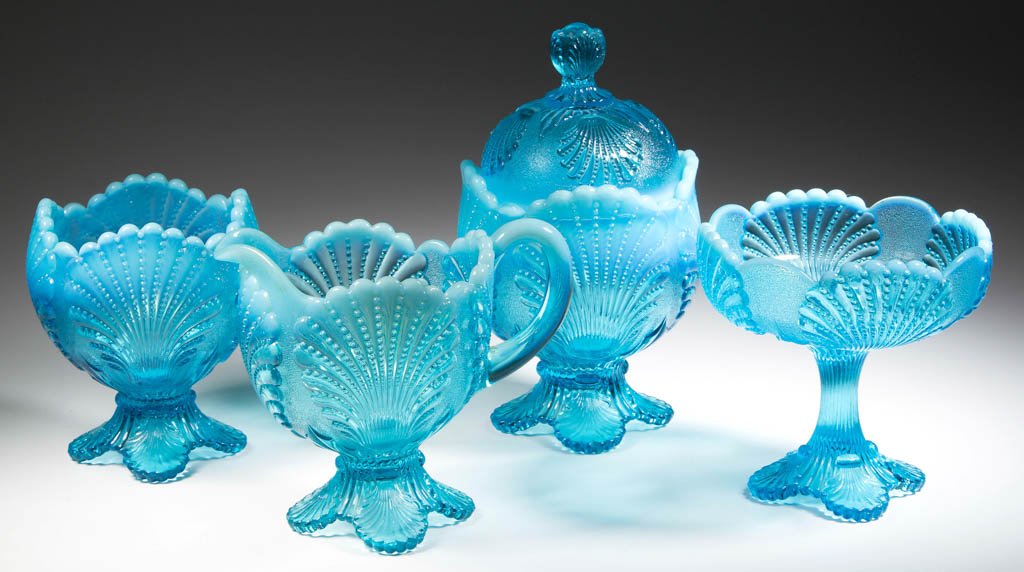 NEW YORK (OMN) / SHELL TABLE ARTICLES, LOT OF FOUR: NEW YORK (OMN) / SHELL TABLE ARTICLES, LOT OF FOUR, blue opalescent, comprising a covered sugar, jelly compote, creamer, and spooner. Dugan Glass Co./National Glass Co. Circa 1900-1910. 4 1/2" to 7 1/