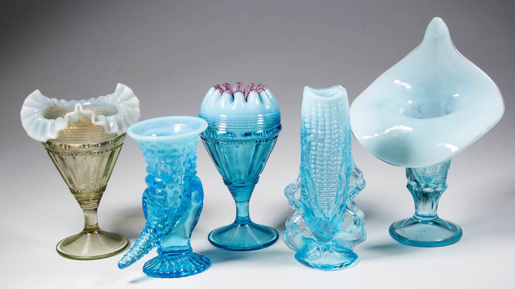 ASSORTED PRESSED OPALESCENT VASES, LOT OF FIVE: ASSORTED PRESSED OPALESCENT VASES, LOT OF FIVE, colorless and blue opalescent, including a Corn, a Cornucopia, and two Fluted Bars and Beads examples. First half 20th century. 6" to 9 3/8" HOA. Proven