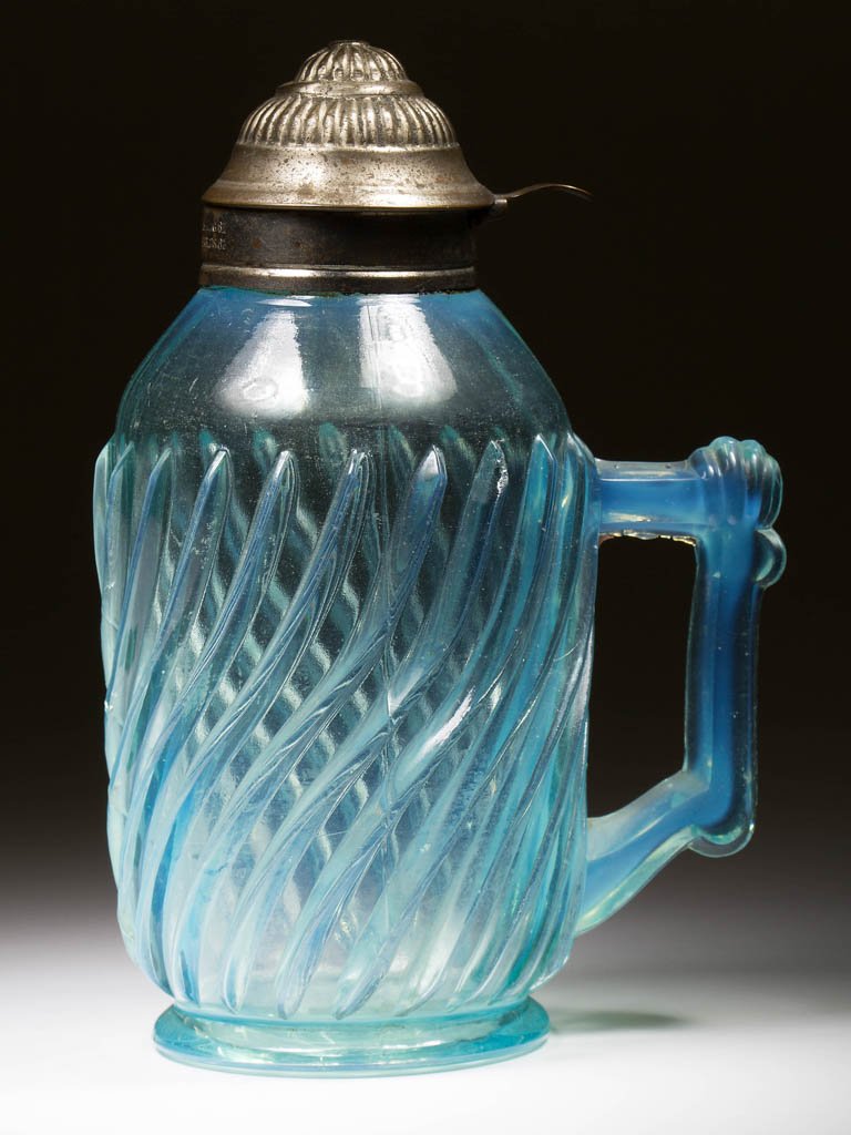 BEATTY SWIRL SYRUP PITCHER: BEATTY SWIRL SYRUP PITCHER, blue opalescent, period lid with patent date. A. J. Beatty & Sons. Circa 1889. 6 3/4" H. Literature: Parallels Heacock/Elmore - Opalescent Glass From A-Z, p. 116, figs. 63,