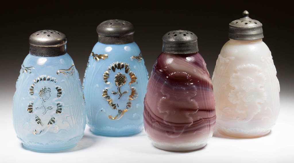CARNELIAN (OMN) / EVERGLADES SALT AND PEPPER SHAKERS,: CARNELIAN (OMN) / EVERGLADES SALT AND PEPPER SHAKERS, TWO PAIR, purple slag and blue opalescent with gilt decoration, period lids. Northwood Glass Co. Circa 1903. 3 1/2" HOA. Literature: Parallels Hea