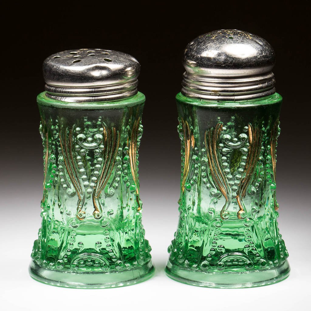 IDYLL SALT AND PEPPER SHAKERS, LOT OF TWO: IDYLL SALT AND PEPPER SHAKERS, LOT OF TWO, green opalescent, later lids. Jefferson Glass Co. Pattern introduced 1907. 3 3/8" and 3 5/8" HOA. Literature: Parallels Heacock/Elmore - Opalescent Glass fro