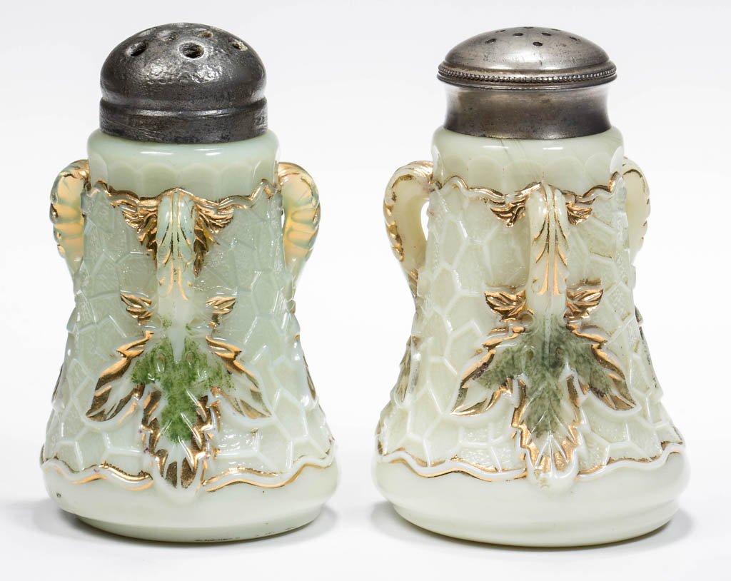 NORTHWOOD MAPLE LEAF PAIR OF SALT AND PEPPER SHAKERS: NORTHWOOD MAPLE LEAF PAIR OF SALT AND PEPPER SHAKERS, custard with green stain and gilt decoration, period lids. Northwood Glass Co. Early 20th century. 3 3/8" H. Literature: Heacock - Encyclopedia of