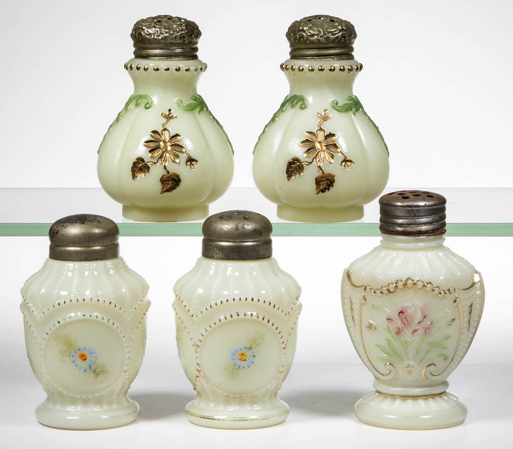ASSORTED CUSTARD GLASS SHAKERS, LOT OF FIVE: ASSORTED CUSTARD GLASS SHAKERS, LOT OF FIVE, gilt and polychrome decorations, comprising two Circled Scroll, two Intaglio, and a Wild Bouquet example, each with a period lid. Late 19th/early 20th cent