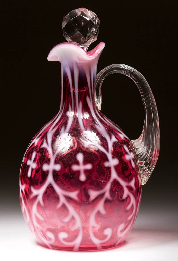 OPALINE BROCADE / SPANISH LACE CRUET: OPALINE BROCADE / SPANISH LACE CRUET, cranberry opalescent, applied colorless reeded handle, facet-cut stopper. Northwood Glass Co. Circa 1899. 6 1/2" HOA. Literature: Heacock/Measell/Wiggins - Harry