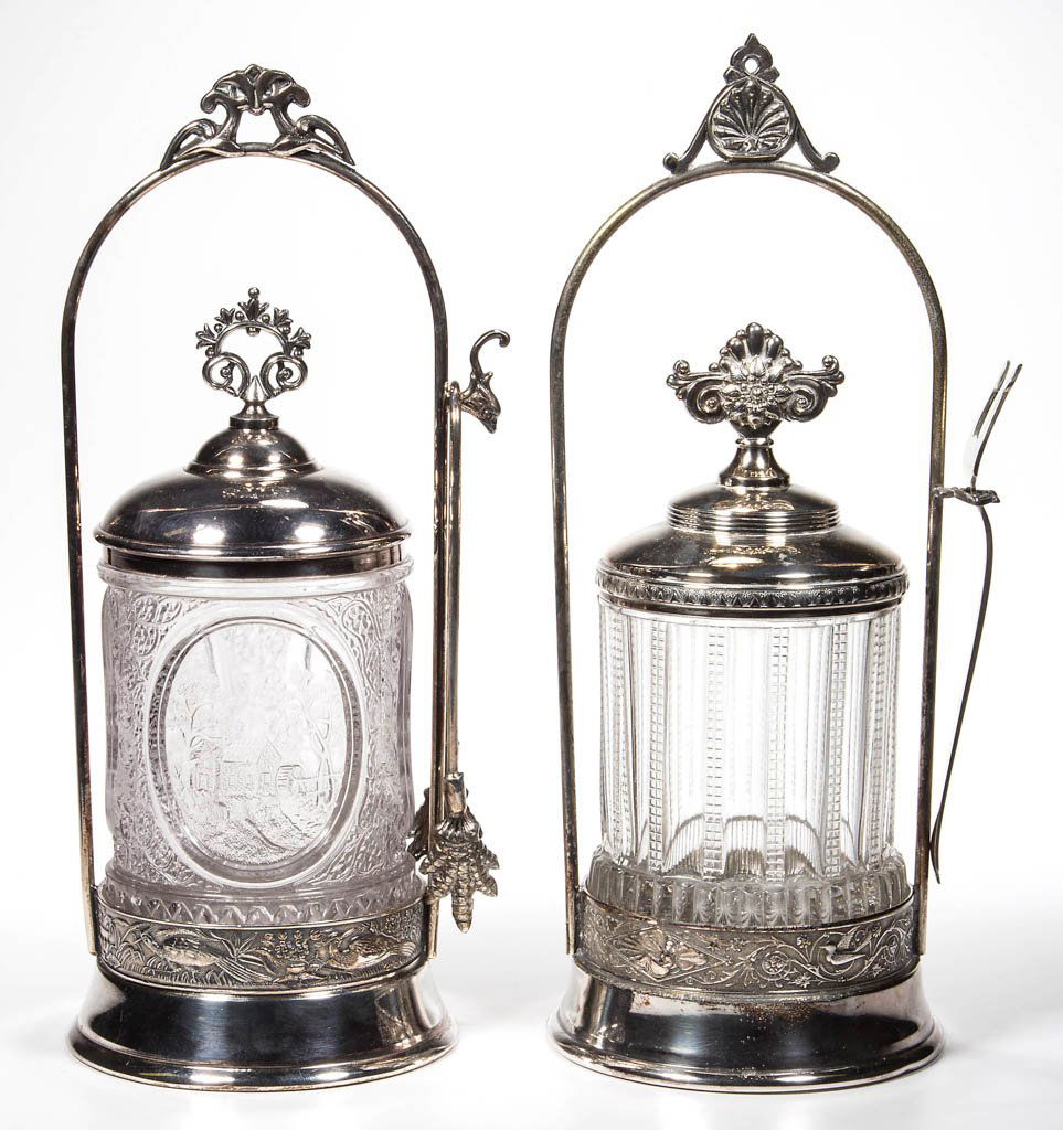 VICTORIAN EAPG PICKLE CASTERS, LOT OF TWO: VICTORIAN EAPG PICKLE CASTERS, LOT OF TWO, colorless inserts, including a Little River, each fitted in an unmarked quadruple-plate stand, one with tongs, the other with fork. Fourth quarter 19th centu