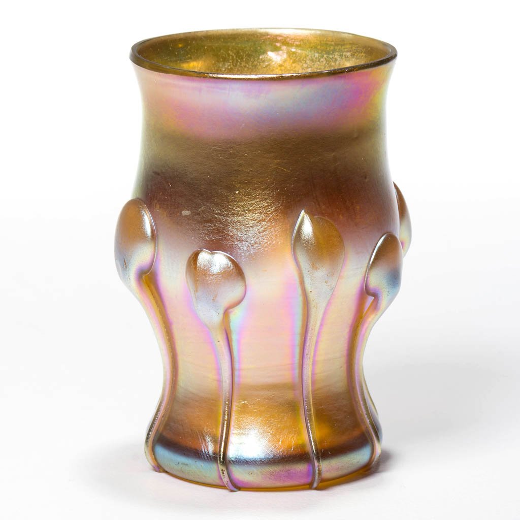 TIFFANY FAVRILE LILY PADS TOOTHPICK HOLDER / LIQUOR: TIFFANY FAVRILE LILY PADS TOOTHPICK HOLDER / LIQUOR TUMBLER, gold iridescent, applied lily pads, factory polished rim, signed "L. C. T. V7648", polished pontil mark. 1904. 2 1/8" H. Literature: Steeg