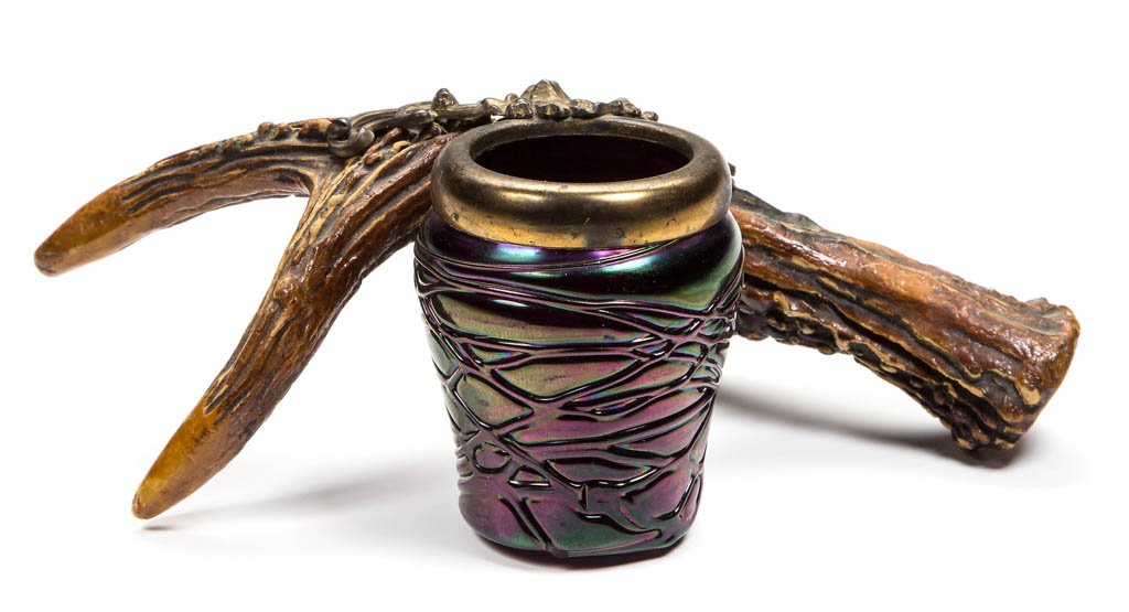 BOHEMIAN ART GLASS TOOTHPICK HOLDER: BOHEMIAN ART GLASS TOOTHPICK HOLDER, amethyst iridescent, with soldered metal decoration attached to an antler. Possibly Loetz/Habel Glassworks. Circa 1900-1910. 2 3/8" H, antler 7" DOA. Literature: P