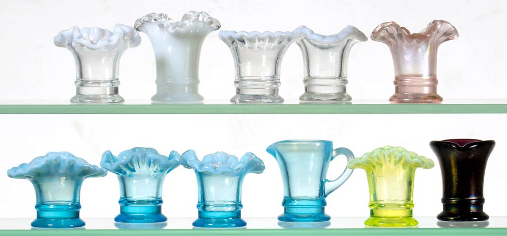 ASSORTED CONTEMPORARY TOOTHPICK HOLDERS, LOT OF 11: ASSORTED CONTEMPORARY TOOTHPICK HOLDERS, LOT OF 11, colorless, amethyst, blue, and vaseline (uranium), including seven examples with a ruffled rim and a toy pitcher. 20th century. 1 1/2" to 2" H. Lite