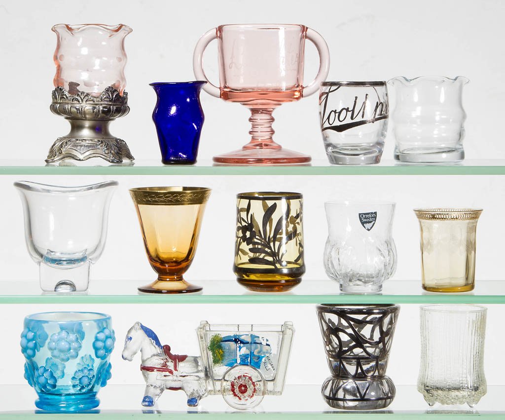 ASSORTED VINTAGE TOOTHPICK HOLDERS, LOT OF 14: ASSORTED VINTAGE TOOTHPICK HOLDERS, LOT OF 14, various colors, including two Myrtle examples, one of which is fitted in a metal stand, an Orrefors example, and a silver-overlay Vigilant example. First