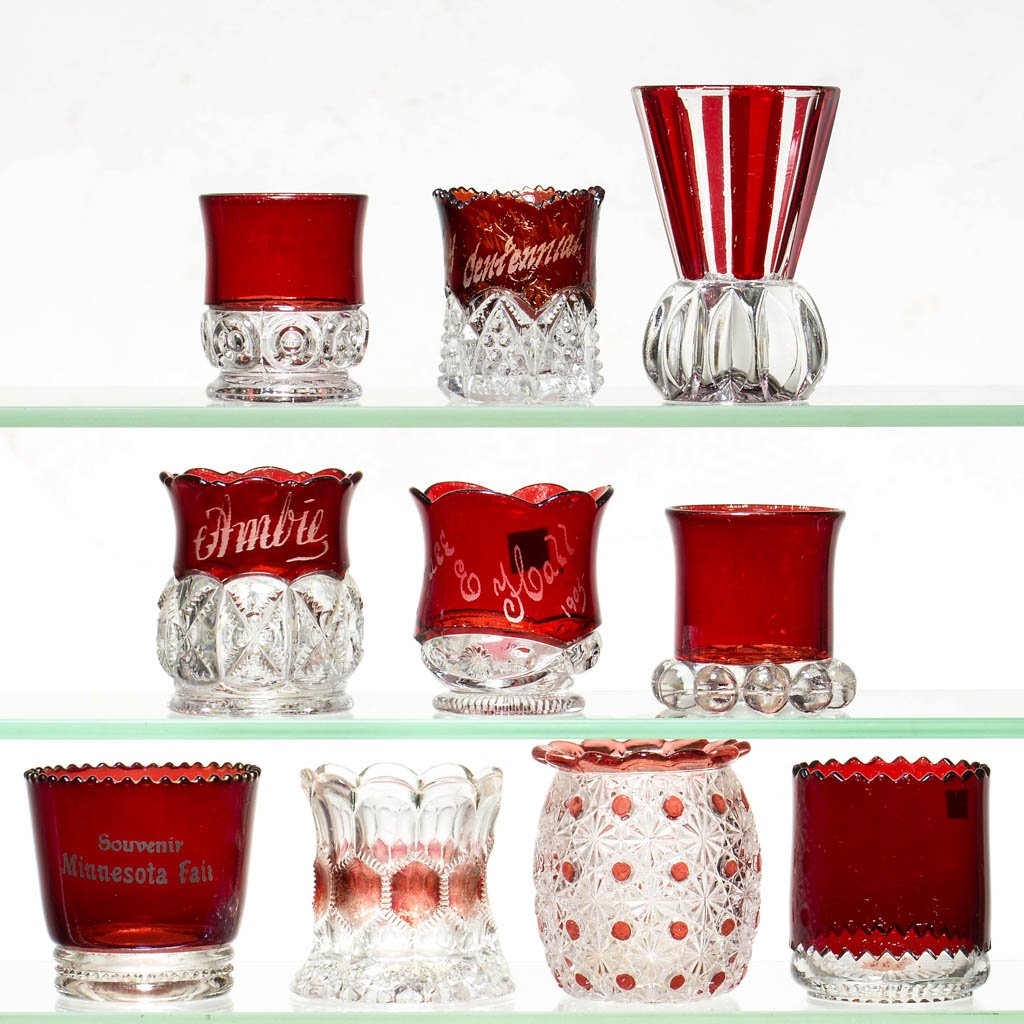 ASSORTED RUBY-STAINED EAPG TOOTHPICK HOLDERS, LOT OF: ASSORTED RUBY-STAINED EAPG TOOTHPICK HOLDERS, LOT OF TEN, colorless, including an Atlas, a Cordova, a Sawtooth Honeycomb, and a Summit example. Late 19th/early 20th century. 2 1/8" to 3 1/4" H. Proven