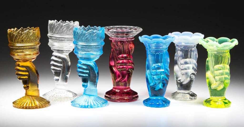 ASSORTED FIGURAL TOOTHPICK HOLDERS, LOT OF SEVEN: ASSORTED FIGURAL TOOTHPICK HOLDERS, LOT OF SEVEN, comprising colorless, amber, and blue Liberty Torch examples, colorless, blue, and vaseline opalescent Fenton Hand ruffled-rim examples, and a cranber