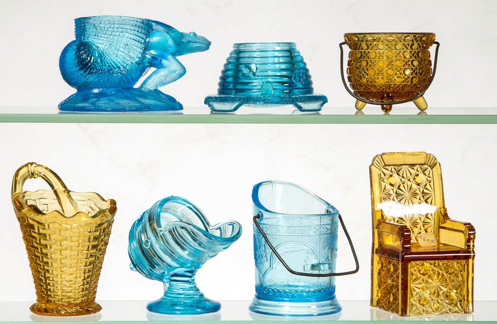 ASSORTED FIGURAL TOOTHPICK HOLDERS, LOT OF SEVEN: ASSORTED FIGURAL TOOTHPICK HOLDERS, LOT OF SEVEN, amber and blue, including a Coal Hod, Daisy Kettle, and Ringed Scoop. Late 19th/early 20th century. 1 3/4" to 4" H. Provenance: The Lowell Wiggins col