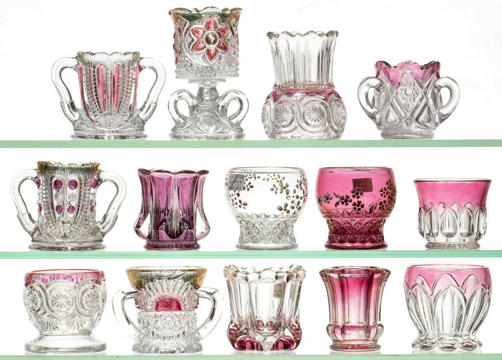 ASSORTED EAPG AND OTHER TOOTHPICK HOLDERS, LOT OF 14: ASSORTED EAPG AND OTHER TOOTHPICK HOLDERS, LOT OF 14, colorless, including a Blazing Cornucopia, Blazing Heart, Minnesota, and a Rising Sun example. Late 19th/early 20th century. 2" to 4" H. Provenanc