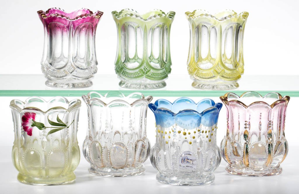 ASSORTED STATE PATTERN EAPG TOOTHPICK HOLDERS, LOT OF: ASSORTED STATE PATTERN EAPG TOOTHPICK HOLDERS, LOT OF SEVEN, colorless with various colored staining, comprising four Michigan and three Galloway/Virginia examples. U. S. Glass Co. Circa 1899. 2 1/2"