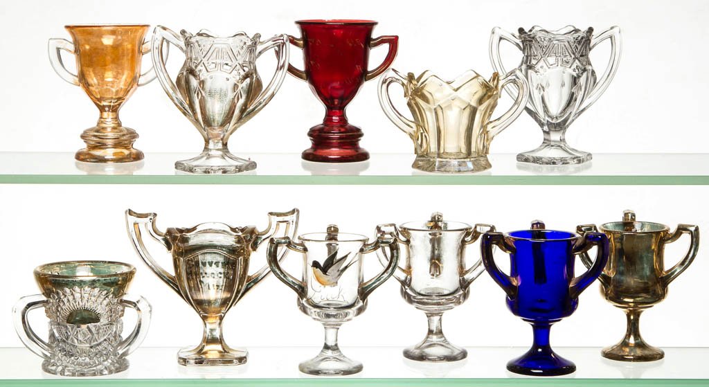 ASSORTED TROPHY / SOUVENIR TOOTHPICK HOLDERS, LOT OF 11: ASSORTED TROPHY / SOUVENIR TOOTHPICK HOLDERS, LOT OF 11, colorless with gilt decoration, including two Paneled and five triple handled examples. Late 19th/early 20th century. 2 1/2" to 3 1/2" HOA. Pro