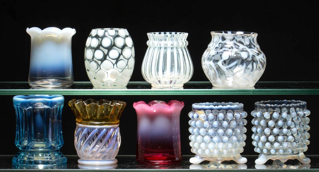 ASSORTED OPALESCENT TOOTHPICK HOLDERS, LOT OF NINE: ASSORTED OPALESCENT TOOTHPICK HOLDERS, LOT OF NINE, colorless, blue, and cranberry opalescent, including an Adonis/Gonterman Swirl, two LaBelle, and two Overall Hobnail examples. Late 19th/early 20th