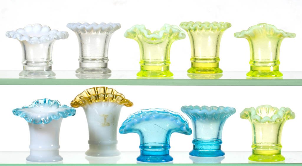 ASSORTED CONTEMPORARY OPALESCENT TOOTHPICK HOLDERS, LOT: ASSORTED CONTEMPORARY OPALESCENT TOOTHPICK HOLDERS, LOT OF TEN, colorless, blue, opal, and vaseline (uranium) opalescent, including a fan vase and two ruffled-rim examples. 20th century. 1 3/4" to 2 1