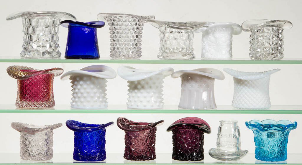 ASSORTED NOVELTY HAT TOOTHPICK HOLDERS, LOT OF 17: ASSORTED NOVELTY HAT TOOTHPICK HOLDERS, LOT OF 17, various colors, including six Daisy and Button and three Hobnail examples. Late 19th/early 20th century. 2 1/2" to 3" H. Provenance: The Lowell Wiggi