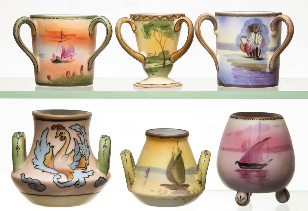 NIPPON CHINA TOOTHPICK HOLDERS, LOT OF SIX: NIPPON CHINA TOOTHPICK HOLDERS, LOT OF SIX, including a Firebird and three sailing themed examples. Five with green M-in-wreath to the underside. First quarter 20th century. 2 1/4" to 2 7/8" H. Litera