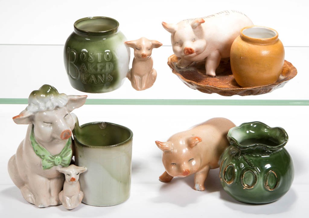 GERMAN PINK PIG FIGURAL CERAMIC TOOTHPICK / MATCH: GERMAN PINK PIG FIGURAL CERAMIC TOOTHPICK / MATCH HOLDERS, LOT OF FOUR, one on an attached tray, the others standing beside the holder, one marked for Boston Baked Beans. First quarter 20th century. 2