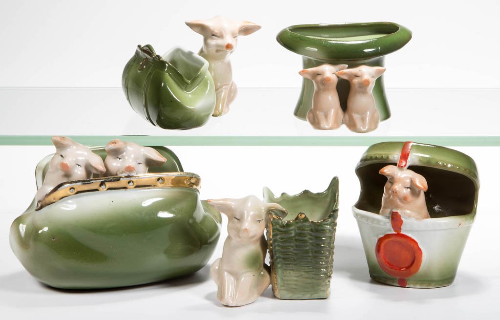 GERMAN PINK PIG FIGURAL CERAMIC TOOTHPICK / MATCH: GERMAN PINK PIG FIGURAL CERAMIC TOOTHPICK / MATCH HOLDERS, LOT OF FIVE, including two with satchel and one peering from a hat box. First quarter 20th century. 2" to 3" H. Provenance: The Lowell Wiggin