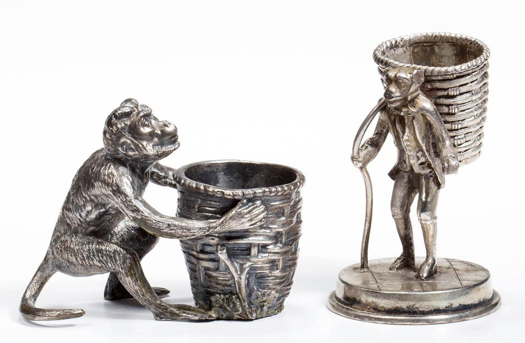 ASSORTED MONKEY FIGURAL SILVER-PLATE TOOTHPICK HOLDERS,: ASSORTED MONKEY FIGURAL SILVER-PLATE TOOTHPICK HOLDERS, LOT OF TWO, comprising a Meriden monkey figure with a travel pack signed and numbered "1" and a probably James W. Tufts monkey with basket examp
