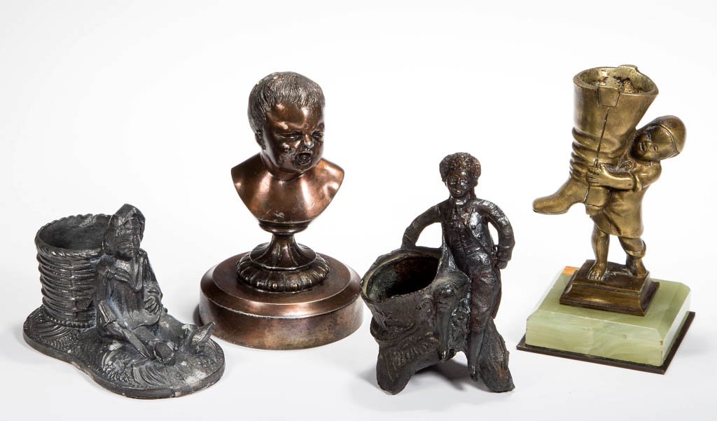 ASSORTED METAL FIGURAL TOOTHPICK / MATCH HOLDERS, LOT: ASSORTED METAL FIGURAL TOOTHPICK / MATCH HOLDERS, LOT OF FOUR, including a brass Child with Boot on an onyx base, and a James Tufts copper-patinated quadruple-plate Baby's Bust. Fourth quarter 19th/fi