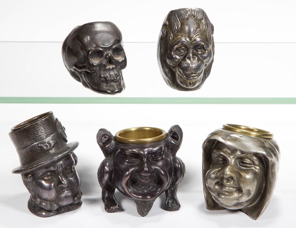 ASSORTED SILVER-PLATED FIGURAL BUST TOOTHPICK / MATCH: ASSORTED SILVER-PLATED FIGURAL BUST TOOTHPICK / MATCH HOLDERS, LOT OF FIVE, including a Gorilla with Crane & Breed advertising on reverse, a Skull, and a Man in Tophat. Fourth quarter 19th/first quart