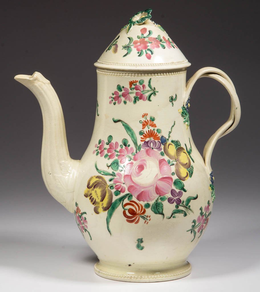ENGLISH STAFFORDSHIRE POTTERY CREAMWARE COFFEE POT AND: ENGLISH STAFFORDSHIRE POTTERY CREAMWARE COFFEE POT AND A COVER, the body of baluster form with entwined strap handles and S-form foliate molded spout, with floriform knop to the cover, with applied sp